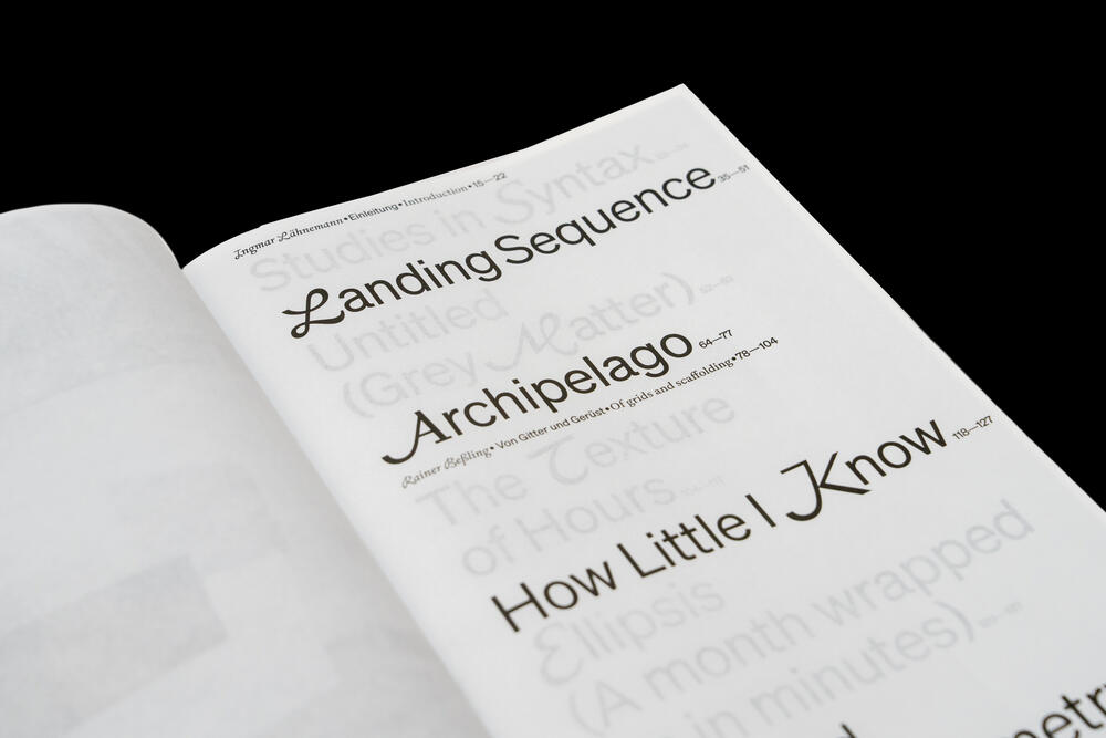 An open book page displaying section titles including "Landing Sequence," "Archipelago," and "How Little I Know," with faded text visible beneath each heading on a white page against a black background.